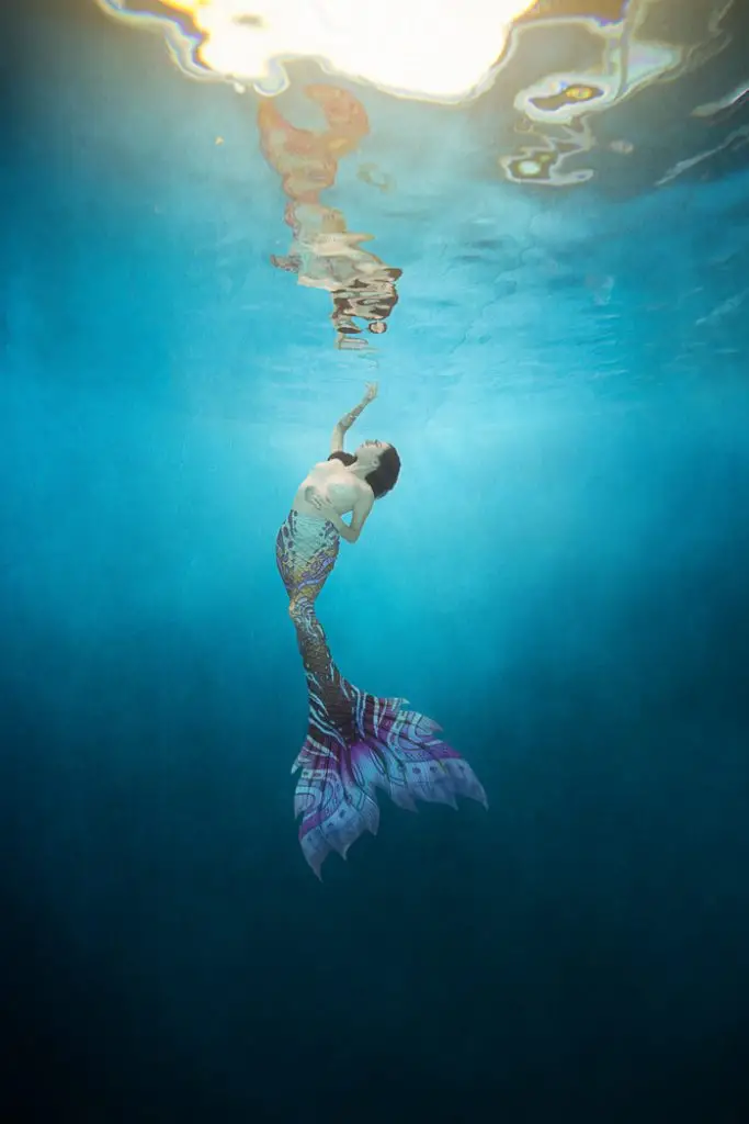 woman in a mermaid tail during an underwater portrait photoshoot